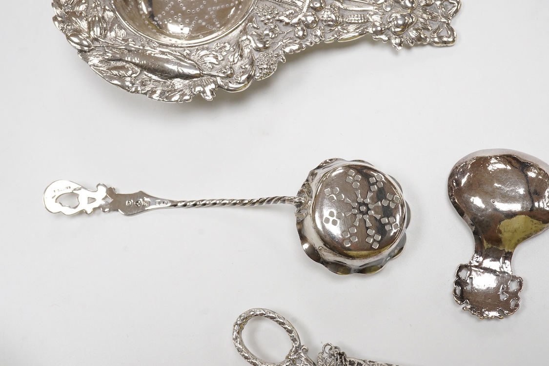 Small silver and white metal, including an Edwardian silver tea strainer, import marks for London, 1908, 15.7cm, a late Victorian silver sifter spoon, silver handled scissors with case, a white metal corkscrew and a whit